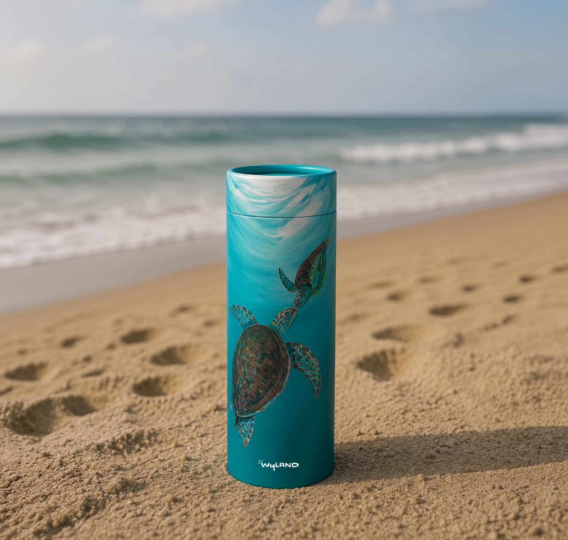 Scattering Tube with Wyland's sea turtles artwork, standing on a beach