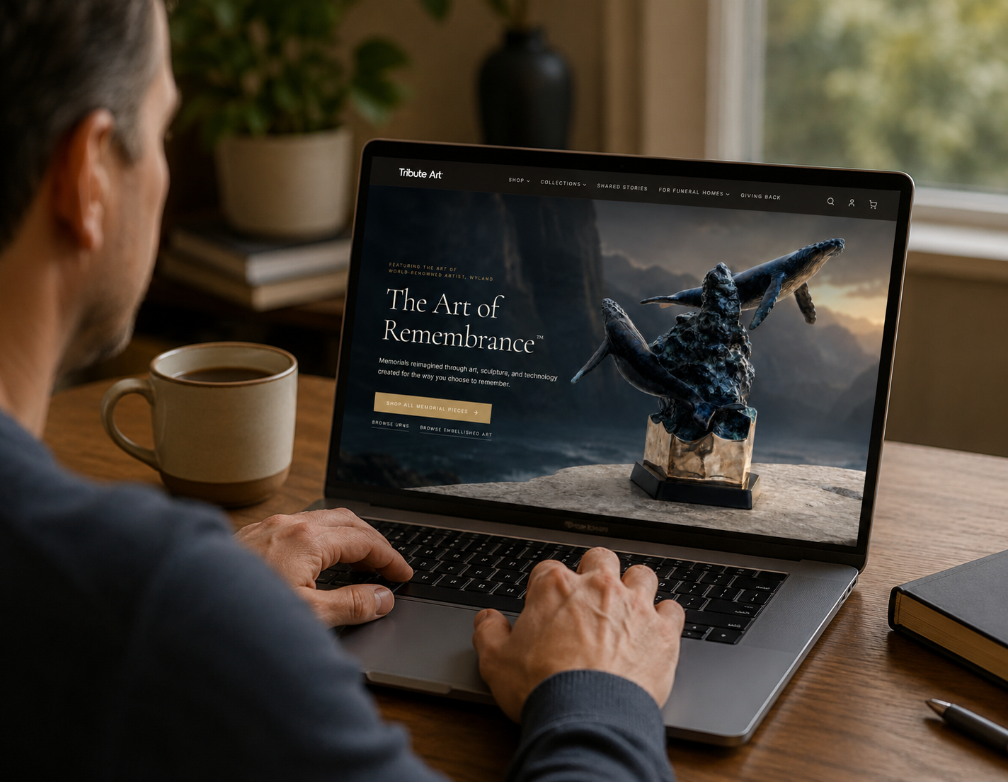 Tribute Art by Wyland™ website displayed on a laptop in a cozy home setting