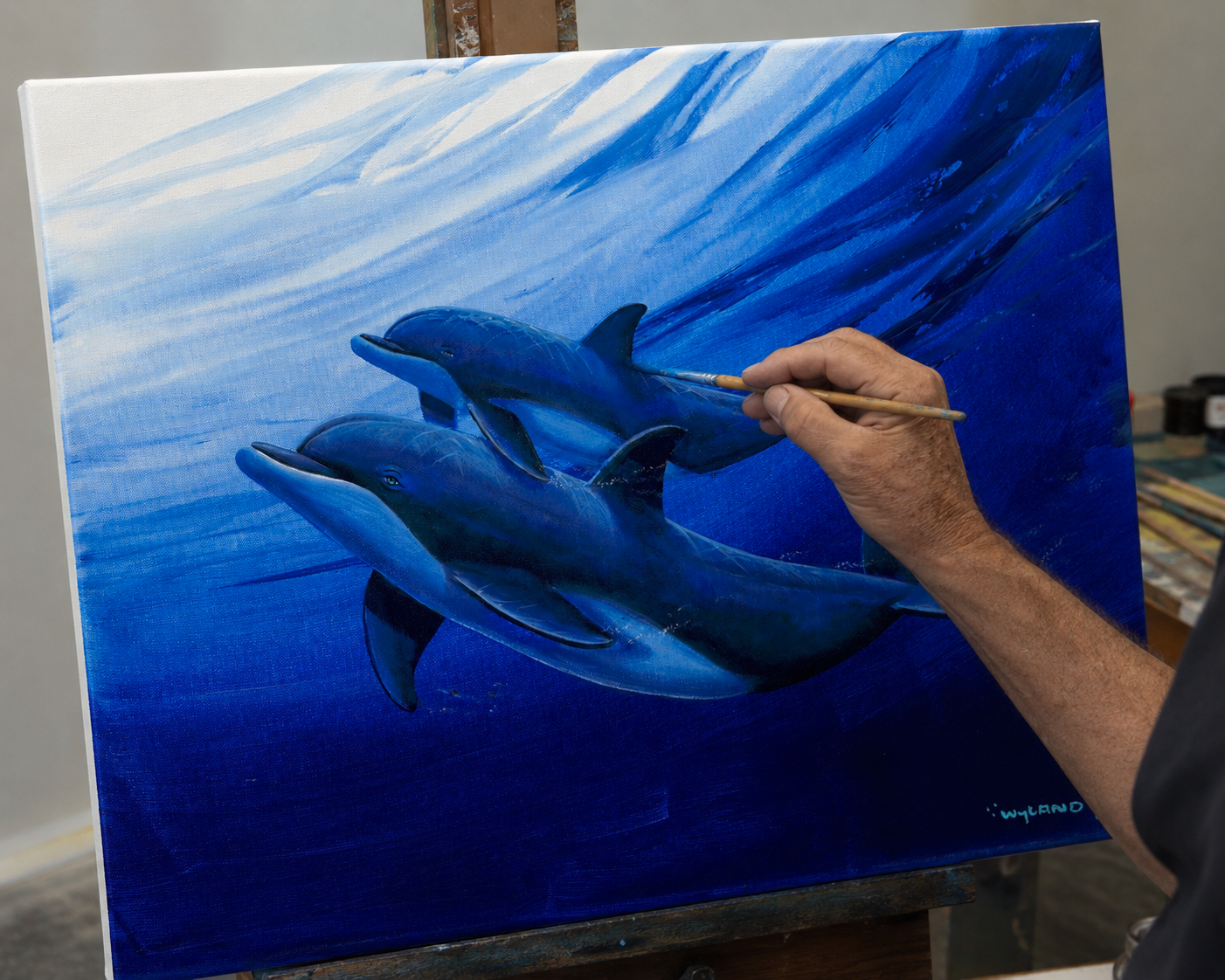 An artist embellishing a painting in the studio